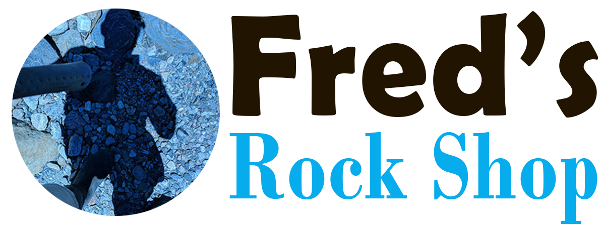 Fred's Rock Shop logo, a round blue photo of a shadow on gravel beside the words Fred's in black and Rock Shop in blue, from the official Fred's Rock Shop website.