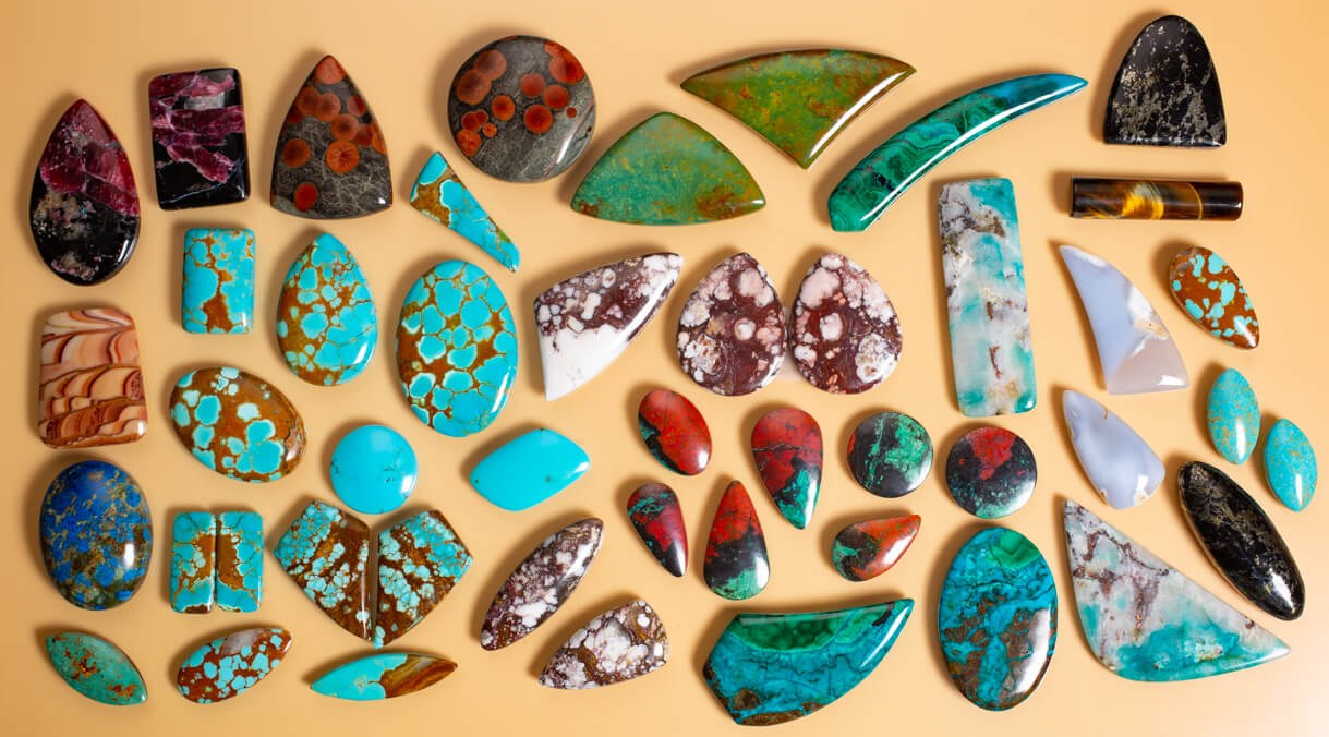 Polished stone slabs cut into cabochon shapes, featured image from the official NC State Crafts Center Cabochons class page.
