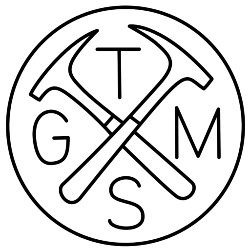 TGMS logo with crossed rock hammers inside a circle, from the official Topeka Gem and Mineral Society website.