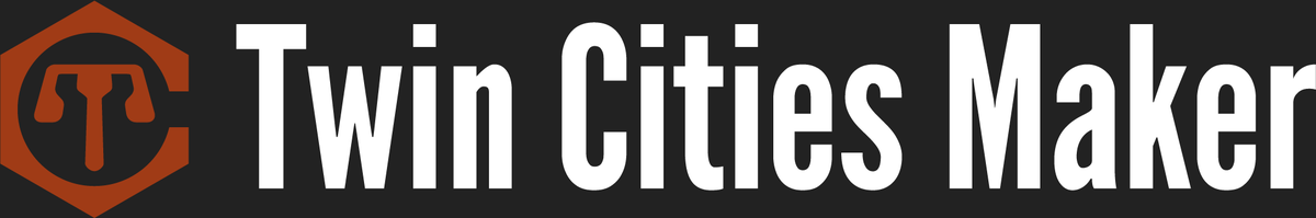 Twin Cities Maker logo, a rust-orange hexagon with a C-shaped cutout around a stylized T, beside the words Twin Cities Maker in white condensed letters on a dark gray background, from the official Twin Cities Maker website.